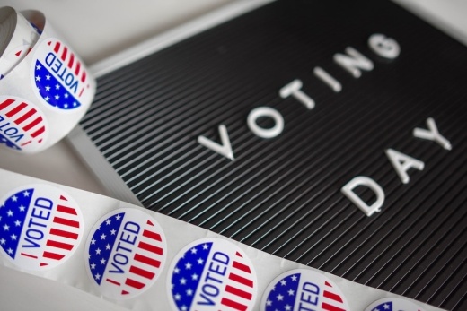 sign that says voting day with i voted stickers