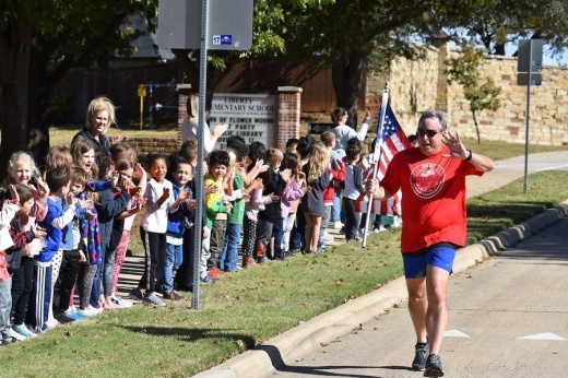 Picture of a man running with an American flag in his hand