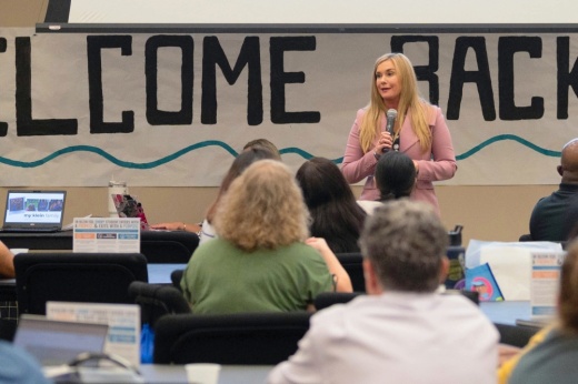 A photo of Jenny McGown speaking to new employees