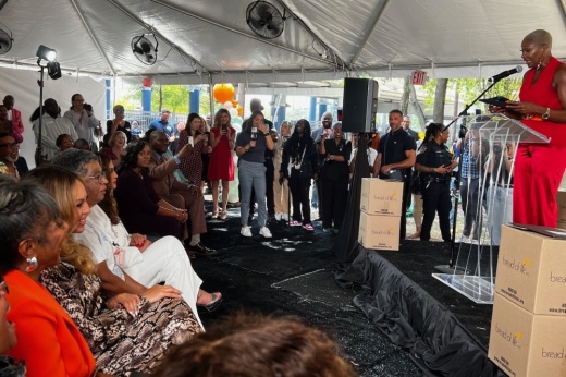 Beyonce and Tina Knowles sitting with members of nonprofit Bread of Life.