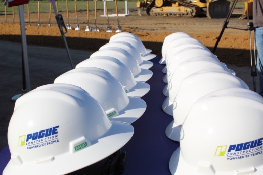 two rows of hard hats on a table