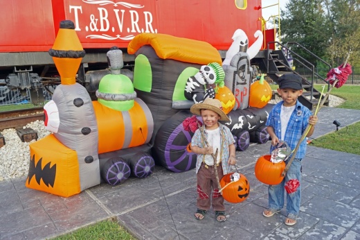 Kids in Halloween costumes with inflatable spooky train