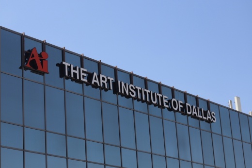 A sign that says "The Art Institute of Dallas" with the school's logo