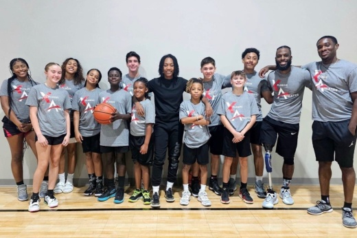 The photo shows a group of kids with a basketball.
