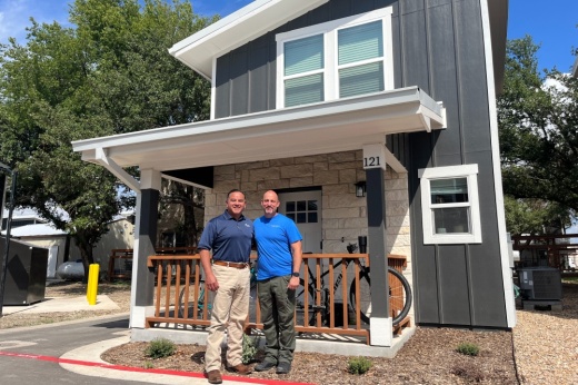 Mustard Seed founder Joseph Claypool and loan officer Rene Flores in front of a Mustard Seed home
