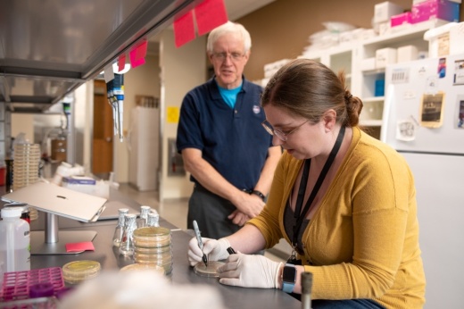 Professor instructing student in biology lab