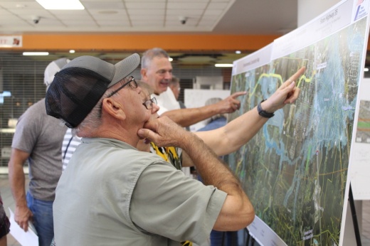 Man looks at map of Grand Parkway plan