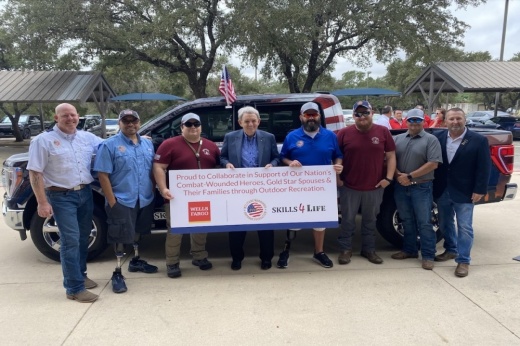Image of Wells Fargo, veterans group members and truck