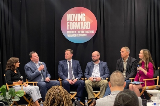 People in a panel sitting down