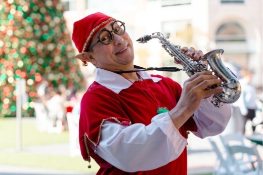Elf playing horn at Sugar Land tree lighting ceremony