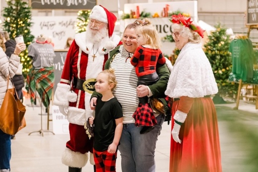 A family takes a photo with Santa