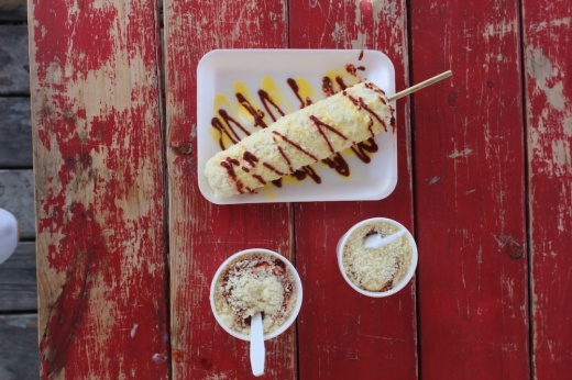 a stick of elotes and two cups
