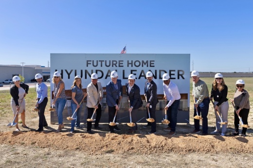 officials in hard hats break ground