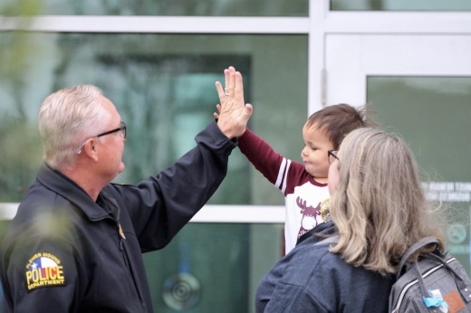 Picture of a man high-fiving a toddler