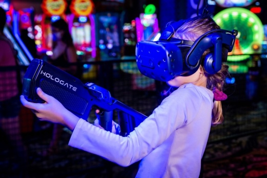 Girl playing virtual reality laser game
