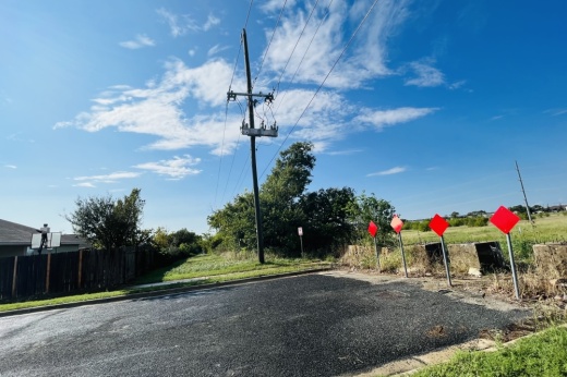 Greenway behind residents next to an empty field.