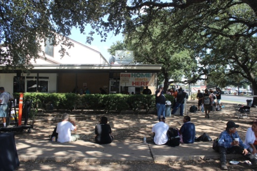 Dozens of clients visit South Austin’s Sunrise Homeless Navigation Center to pick up food and clothing or be connected with support services on Oct. 3. (Ben Thompson/Community Impact)