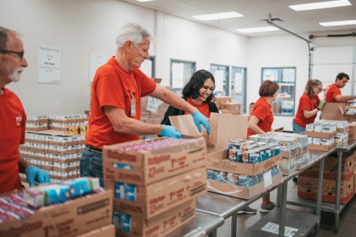 Volunteers with the Montgomery County Food Bank prepare items for distribution.