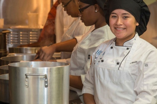 Students from HISD CTE Culinary class stand over pots