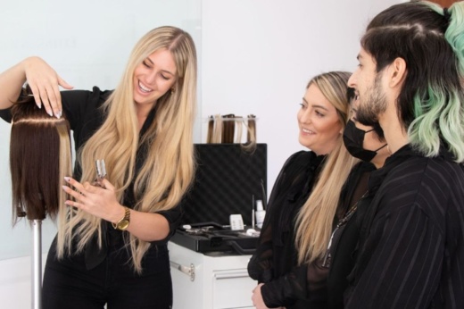 instructor shows stylists about The Hair Shop extensions