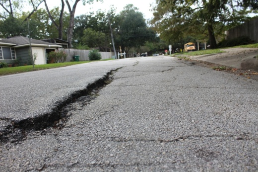 a street in a neighborhood with large cracks