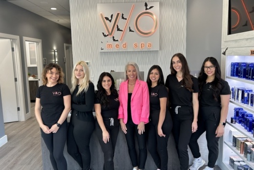 A group of aetheticians at V/O Med Spa pose for a photo inside the location.