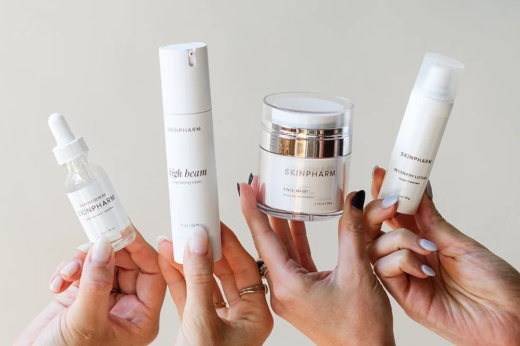 skin products being held up by four hands
