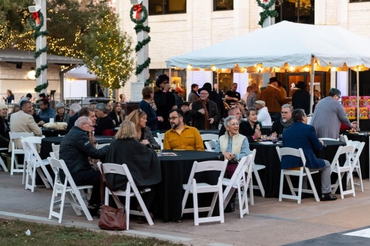 people gathered at tables in downtown round rock