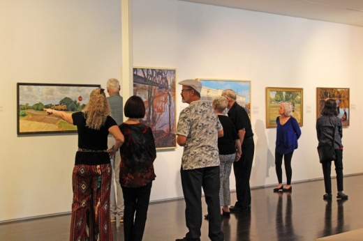 A photo of visitors perusing the gallery at the Pearl Fincher Museum of Fine Arts