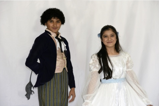 Emiliano Arroyo Corona stands to the left of Celeste Arambula in costume as Fritz and Clara of the Nutcracker.
