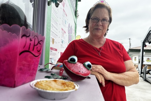Mary Jayne Buckingham poses for a photo behind one of her pies at the trailer.