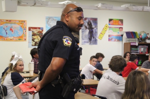 a school resource officer walks around a classroom