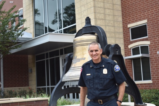 Fire chief in front of memorial bell