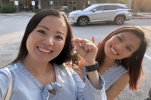 Two women, the owners of EZShip , smile as they hold the key to their new business.