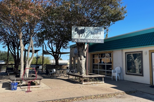 the exterior of a business with some outdoor seating
