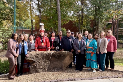 LSC-Montgomery officials and members of the Alabama-Coushatta Tribe pose in front of the Land Acknowledgement monument.