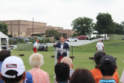 Tournament Chair Jeff Eckert speaking at the event's grand opening event on a golfcourse