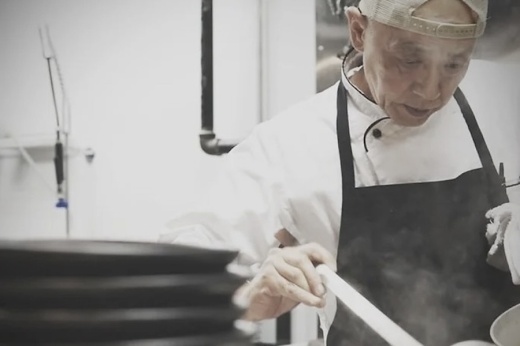 Picture of a man cooking a dish in a kitchen.