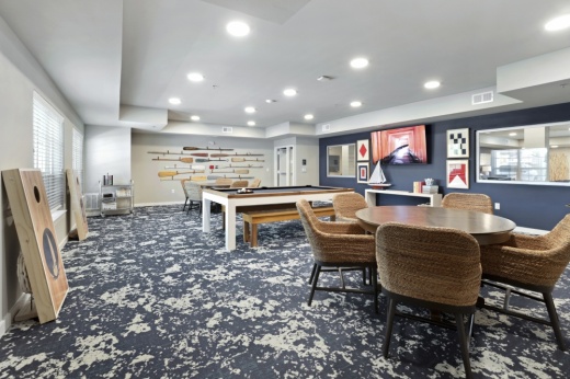 a room with two tables and a pool table between them