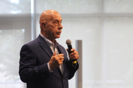 John Whitmire holds a microphone