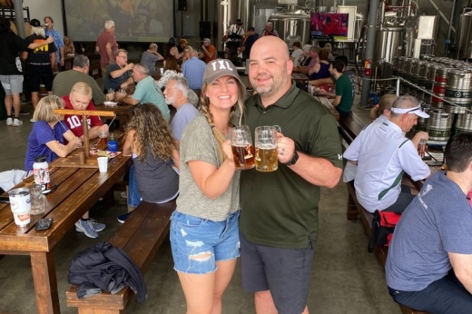 Owners of Sugar Land brewery toasting mugs of beer