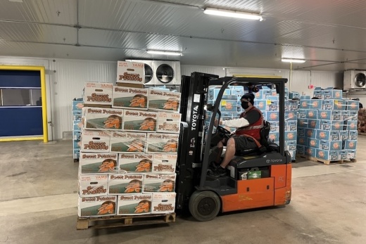 Tarrant Area Food Bank employee Mark Quast readies a pallet of sweet potatoes for distribution in the new agriculture hub. (Mark Fadden/Community Impact)