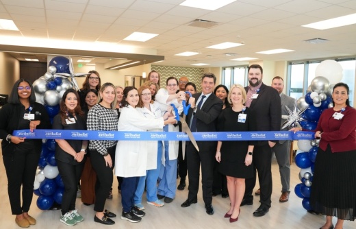 Medical staff cutting grand opening ribbon