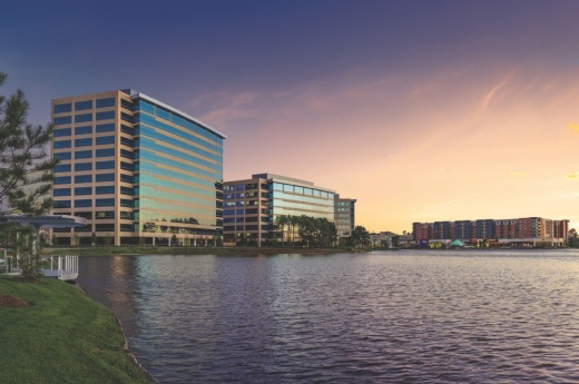 Office buildings on the water at sunset