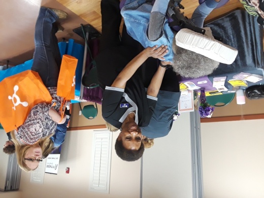 Health care representative giving a back massage at the Health and Home Show.