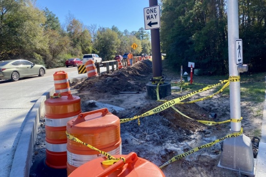 orange cones on the side of a roadway under construction