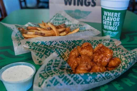 Wingstop wings, a side of fries, a cup of ranch and a drink