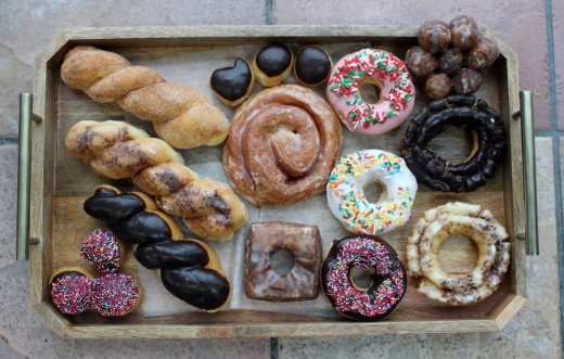 A variety of donuts on a tray.