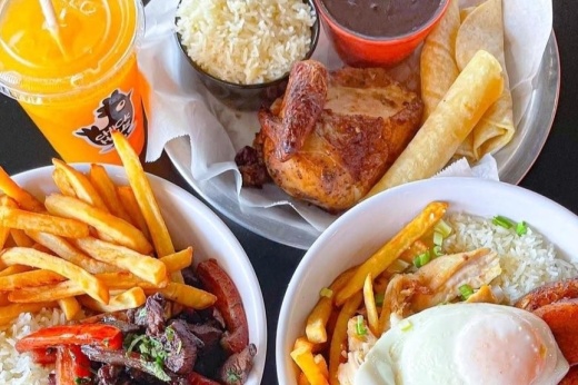 Three plates of food next to a drink