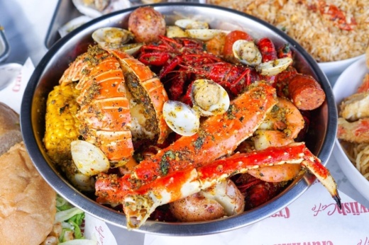 seafood boil with corn, potatoes, sausage, mussels, crab legs, crawfish and lobster tail.
